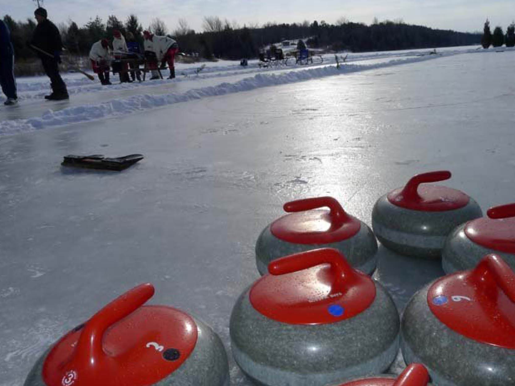 Curling stones on pond ice